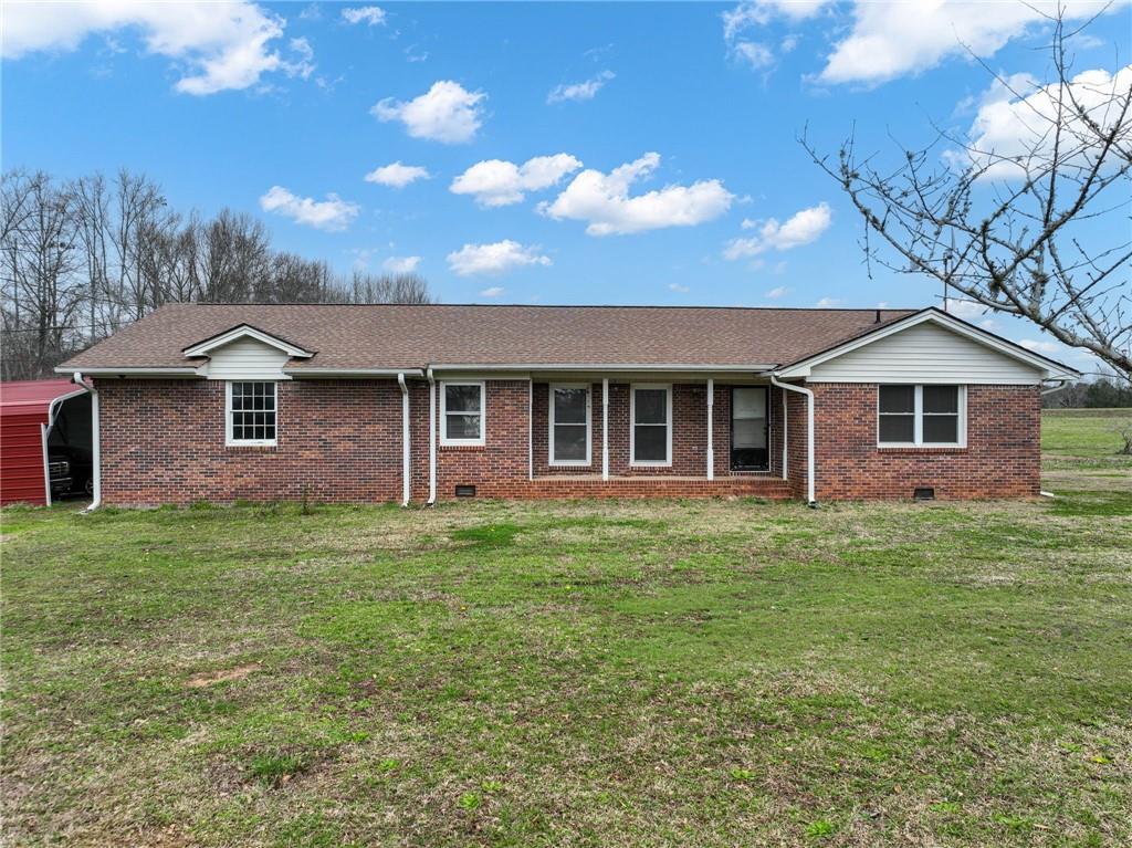 3070 Snows Mill Road Monroe, GA 30655 - Photo 1 of 1 a front view of a house with a garden