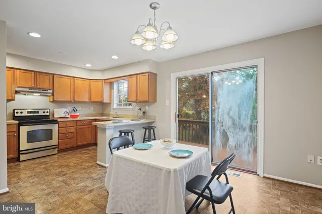 a kitchen with a stove a sink and a refrigerator