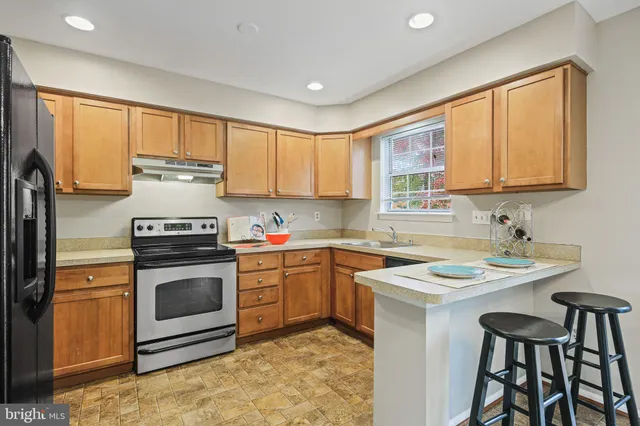 a kitchen with a stove sink and cabinets