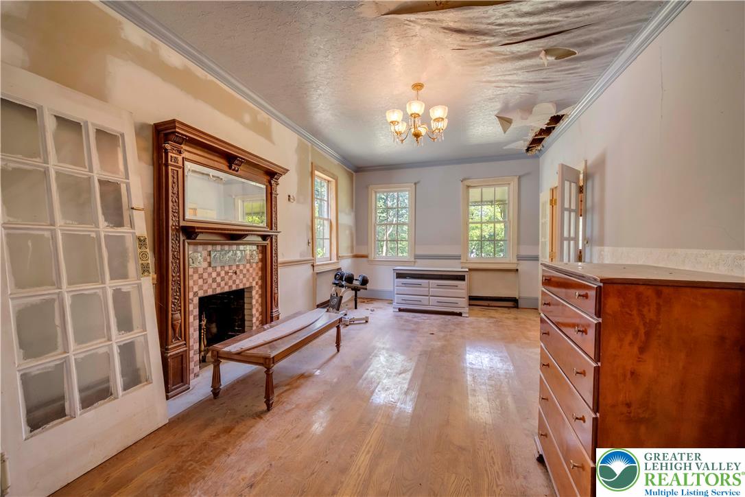 384 Henry Road Nazareth, PA 18064 - Photo 27 of 54 Hardwood floors and an ornate fireplace mantel define this historic living space.
