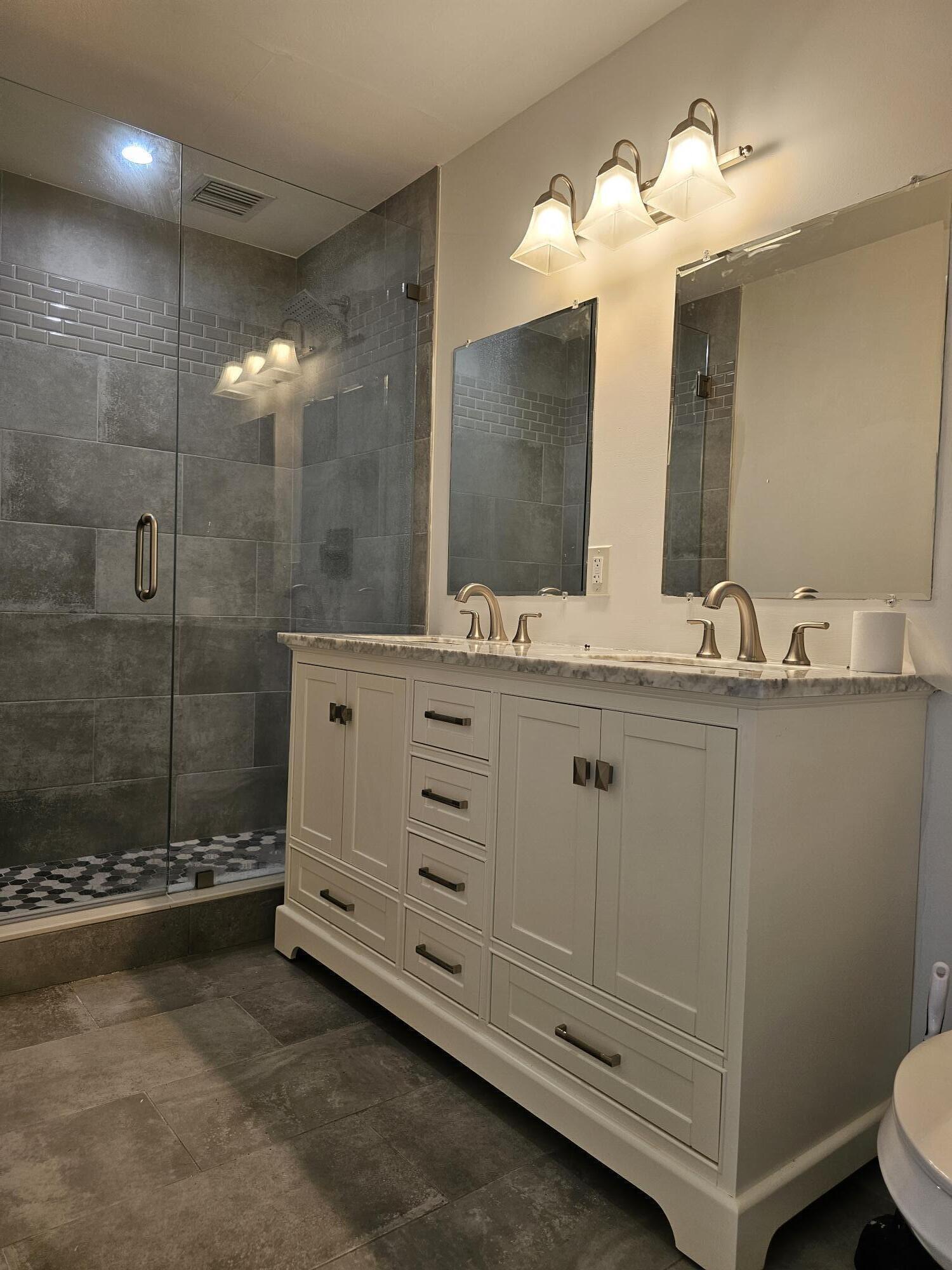 3313 Gulfstream Road Palm Springs, FL 33461 - Photo 31 of 31 a bathroom with a sink a toilet and mirror