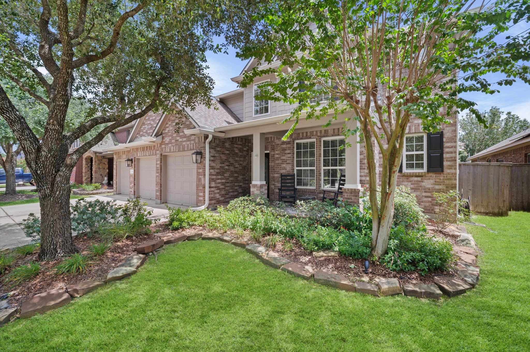 9507 Empress Crossing Drive Spring, TX 77379 - Photo 4 of 50 This charming two-story brick home features a well-maintained front yard with lush landscaping, mature trees, and a cozy porch. It includes a spacious two-car garage and offers excellent curb appeal in a quiet neighborhood setting.
