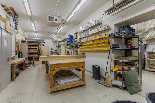 a view of a workspace with furniture and wooden floor