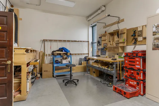 a view of a room with wooden floor and bench
