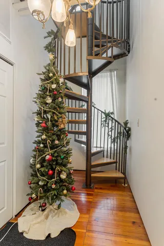 a kitchen with a refrigerator wooden floor and a window
