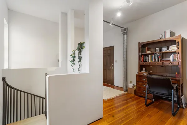 a workspace with furniture and wooden floor