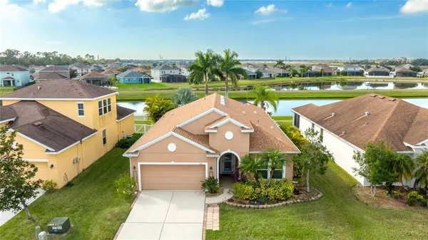an aerial view of a house with big yard