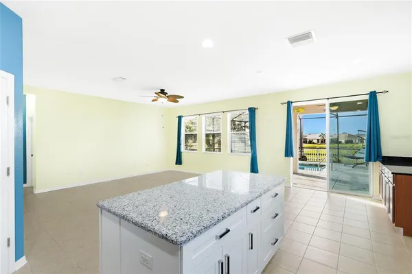 a spacious bathroom with a granite countertop sink and a mirror