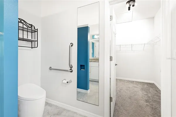a bathroom with a toilet and a shower