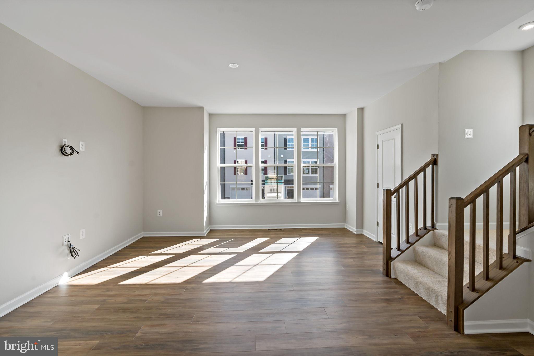 214 Monteith Drive Winchester, VA 22601 - Photo 11 of 31 a view of an empty room with wooden floor and a window