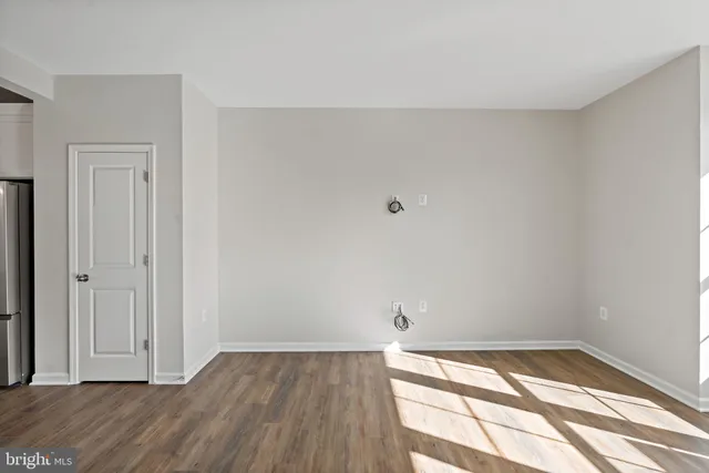 a view of an empty room and wooden floor