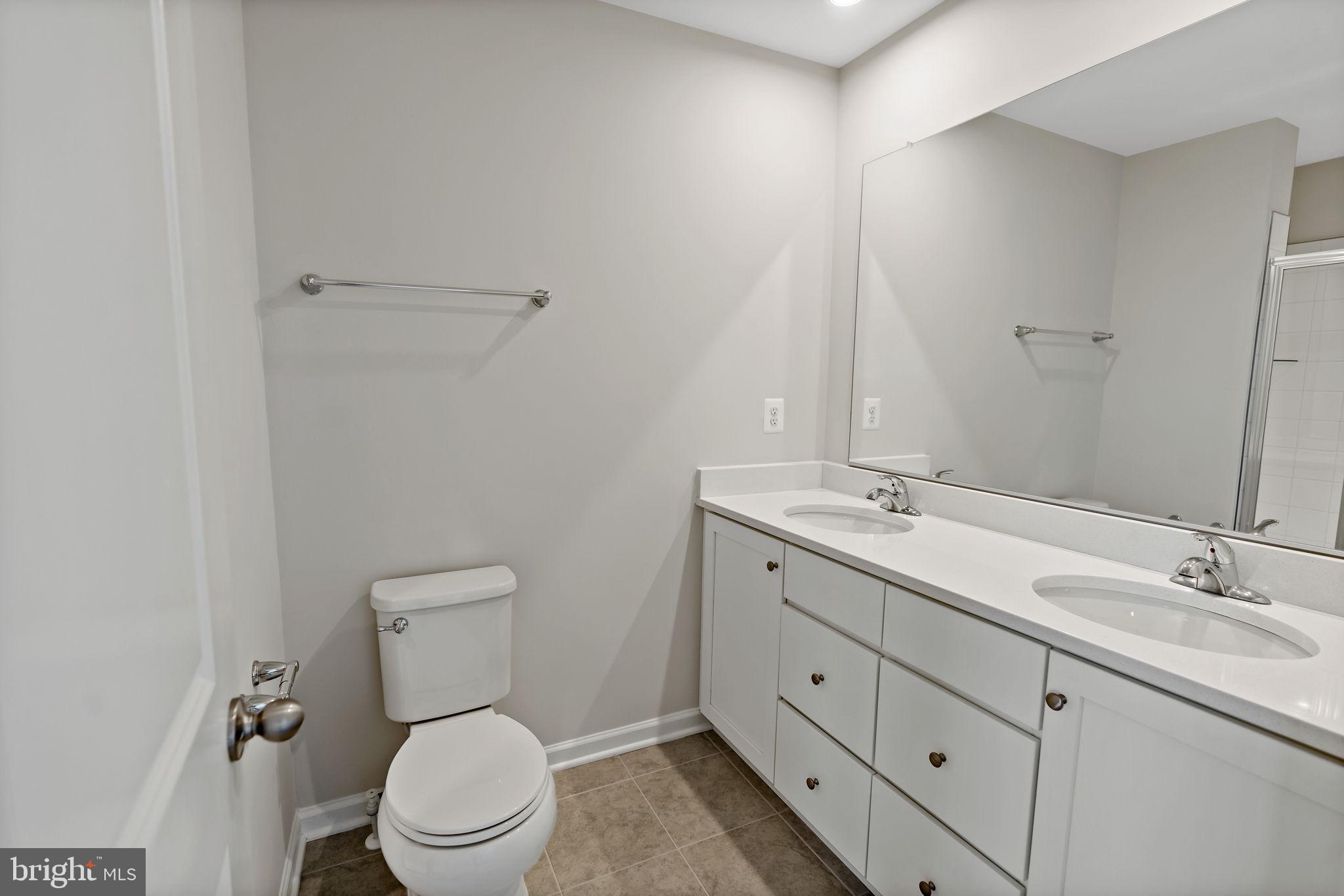 214 Monteith Drive Winchester, VA 22601 - Photo 17 of 31 a bathroom with a double vanity sink toilet and a mirror
