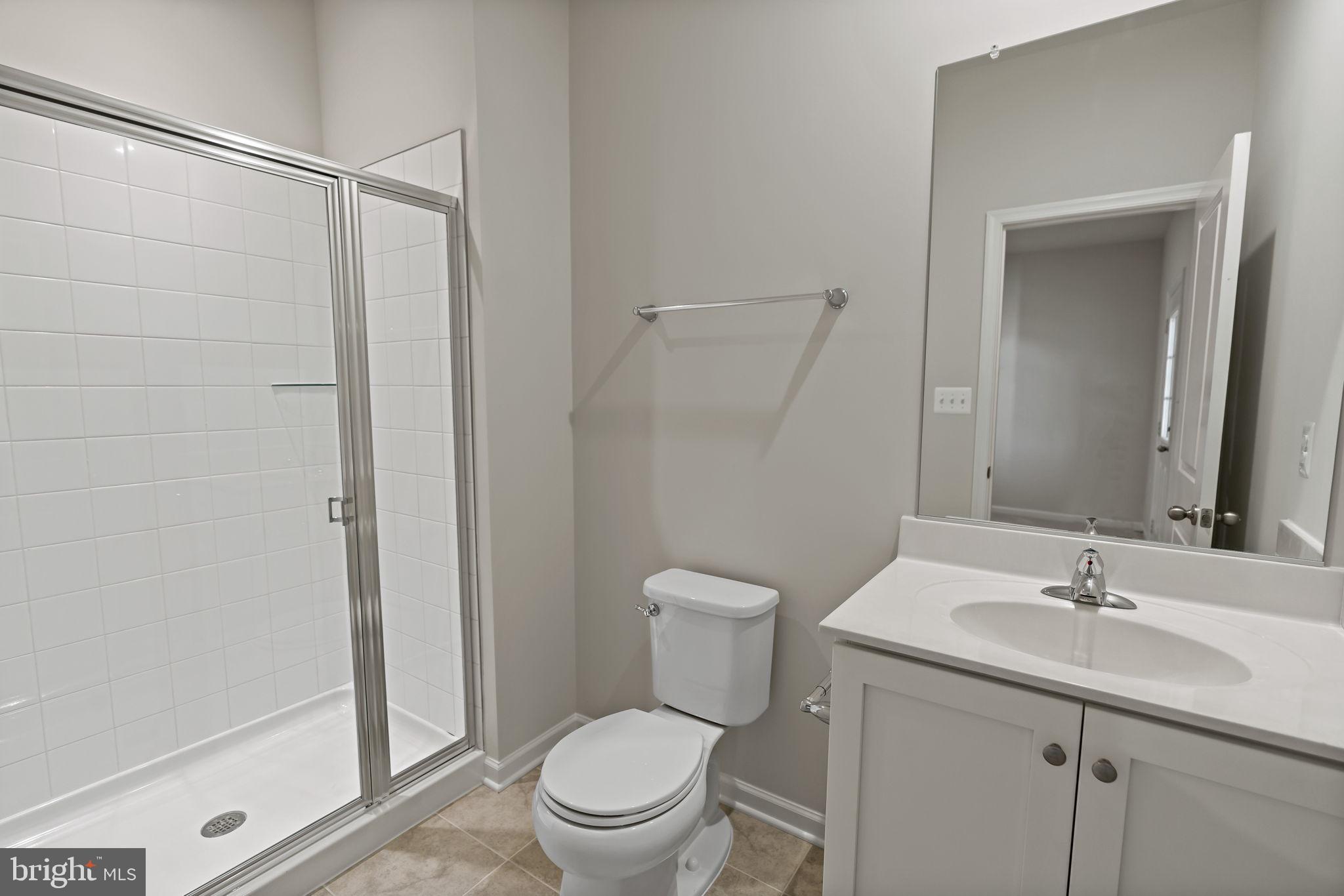 214 Monteith Drive Winchester, VA 22601 - Photo 27 of 31 a bathroom with a shower sink vanity mirror and toilet