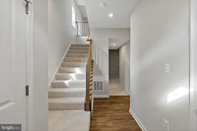 a view of entryway and hall with wooden floor
