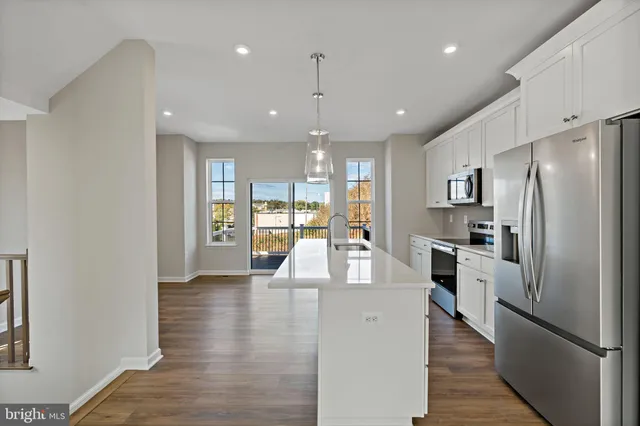 a kitchen with stainless steel appliances a refrigerator sink and stove