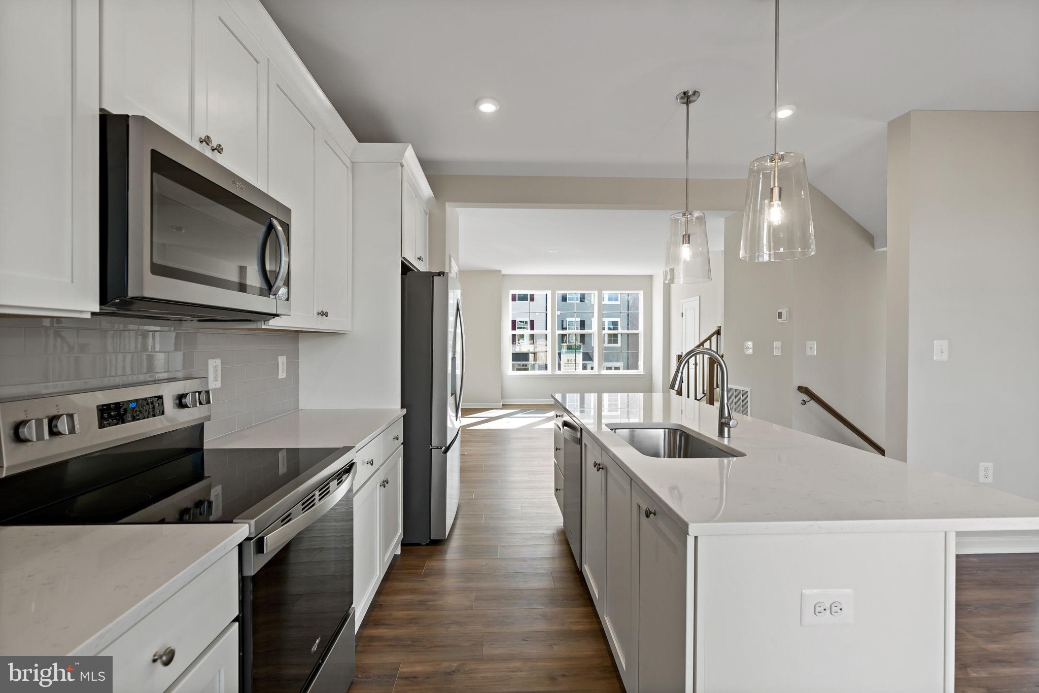 214 Monteith Drive Winchester, VA 22601 - Photo 7 of 31 a kitchen with stainless steel appliances a stove sink microwave and cabinets