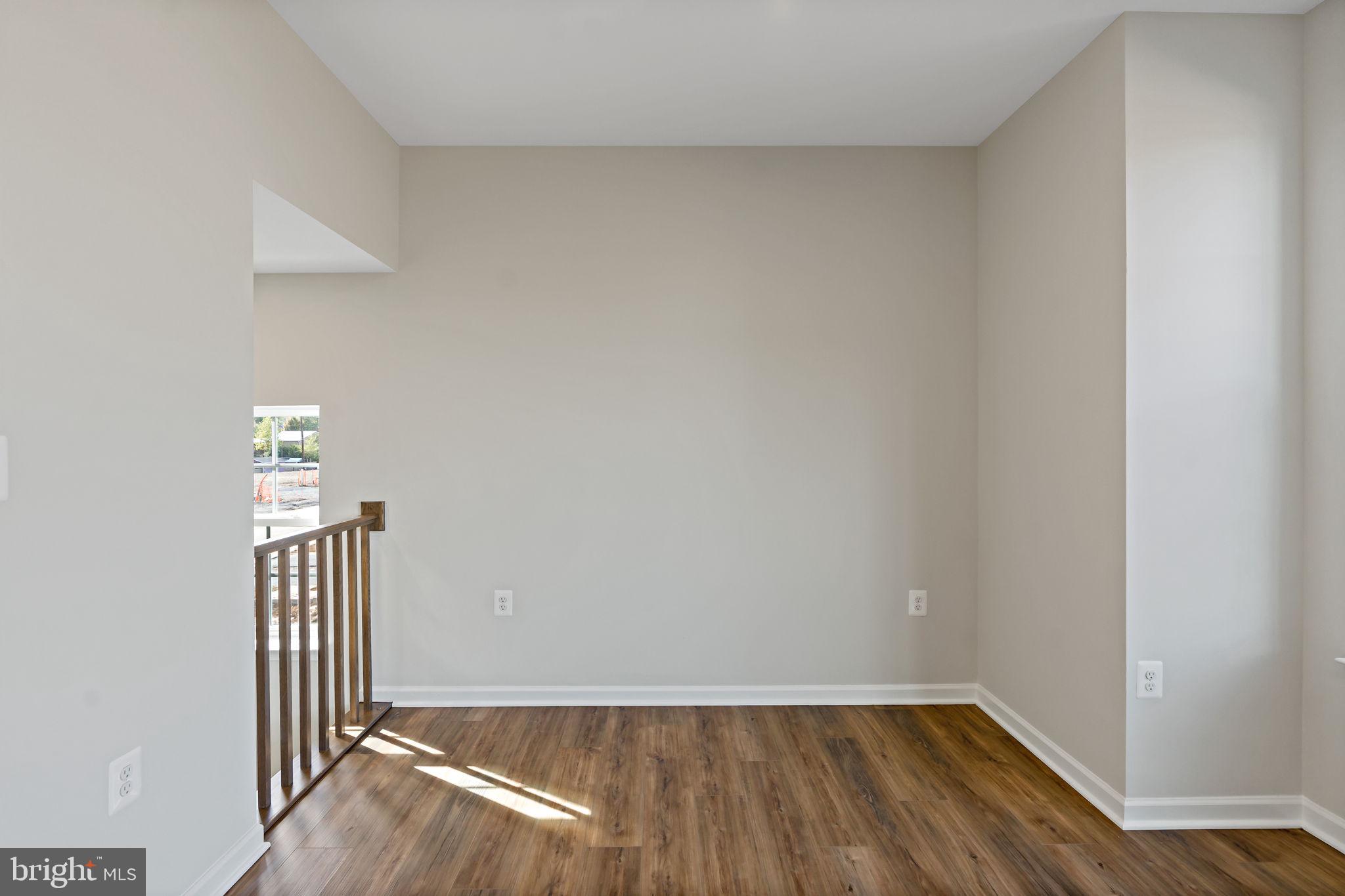 214 Monteith Drive Winchester, VA 22601 - Photo 10 of 31 an empty room with wooden floor and windows