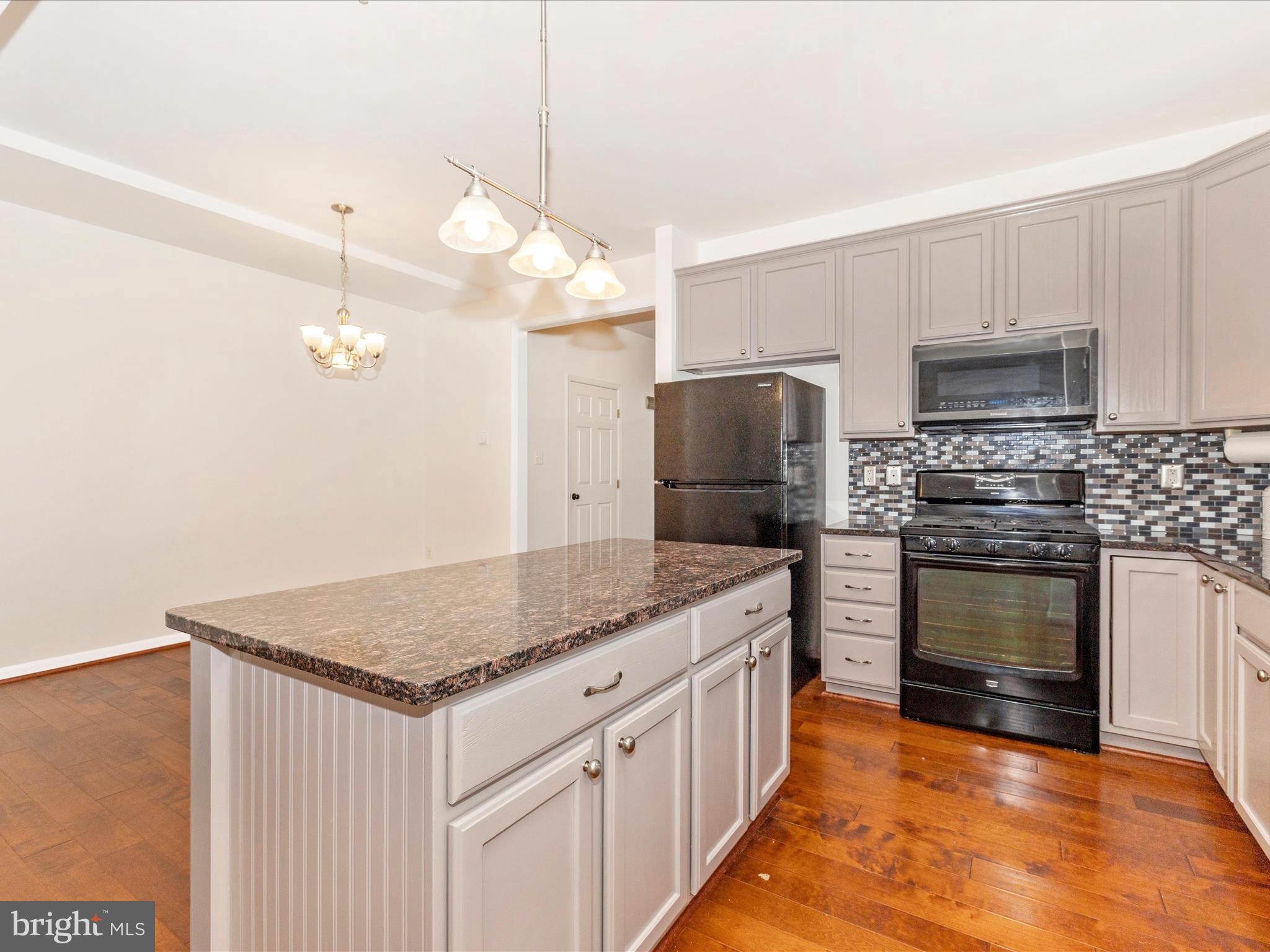 1801 Free Terrace Frederick, MD 21702 - Photo 14 of 62 a kitchen with appliances cabinets a island and a stove
