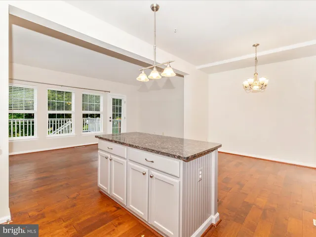 a living room with furniture large windows and a table