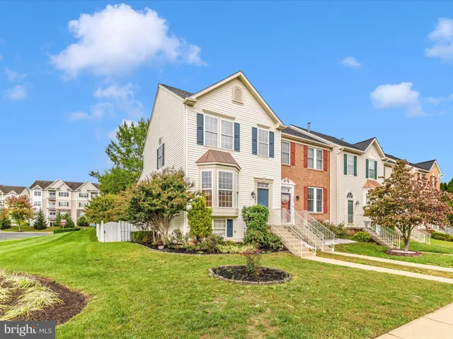 a front view of a house with a yard table and chairs