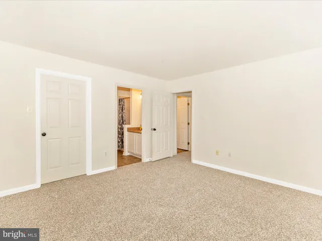a bathroom with a granite countertop sink a toilet and a mirror