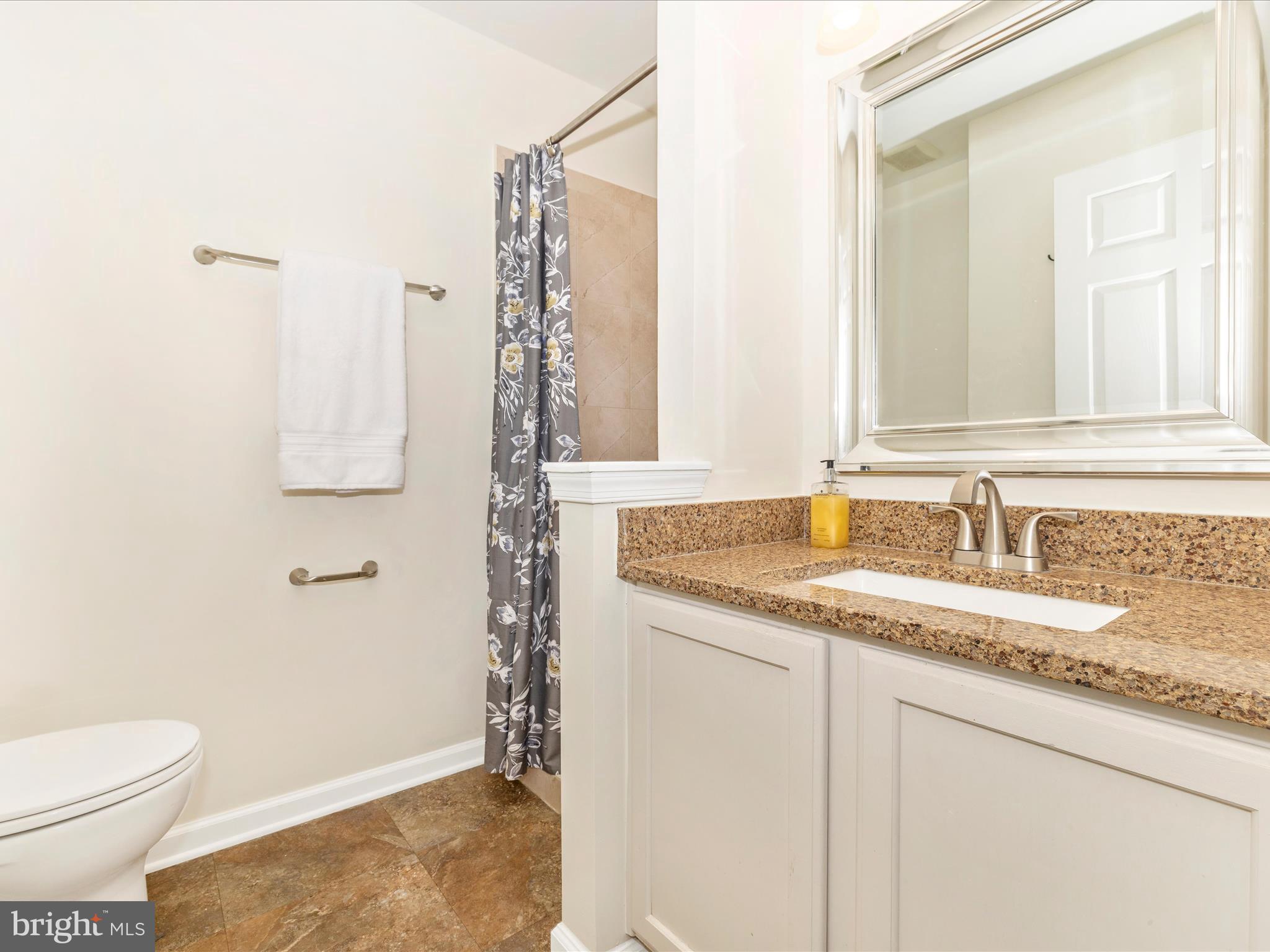 1801 Free Terrace Frederick, MD 21702 - Photo 28 of 62 a bathroom with a granite countertop sink a toilet and a mirror