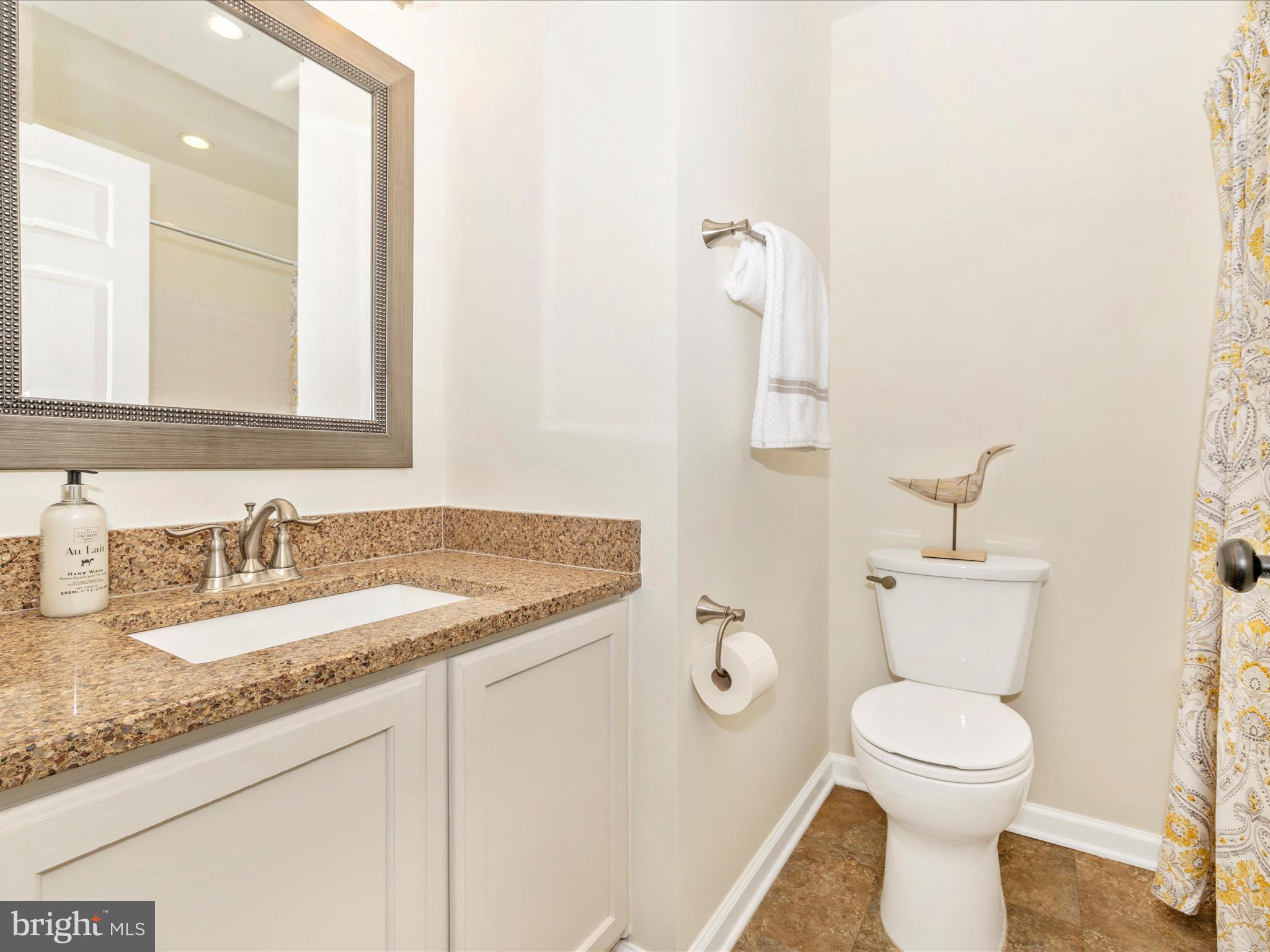 1801 Free Terrace Frederick, MD 21702 - Photo 34 of 62 a bathroom with a granite countertop toilet sink and mirror
