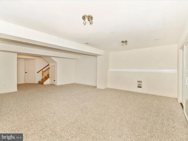 a view of a house with wooden fence