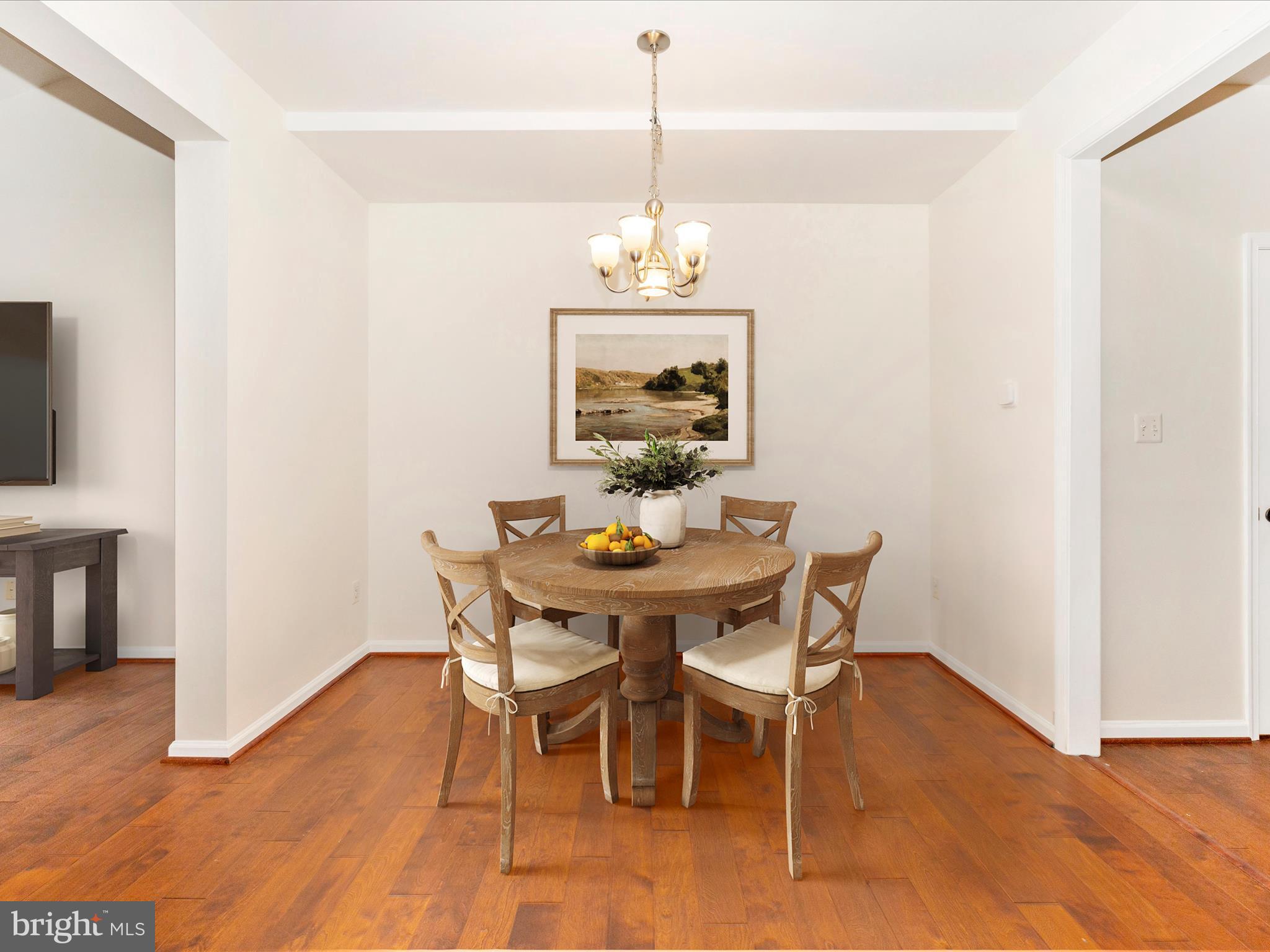 1801 Free Terrace Frederick, MD 21702 - Photo 7 of 62 a dining room with furniture wooden floor a rug and a chandelier