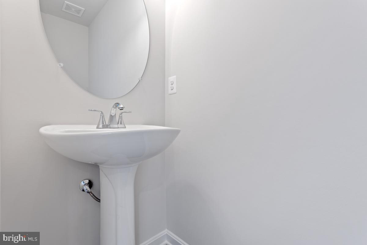 108 Ramshorn Road Inwood, WV 25428 - Photo 7 of 18 a bathroom with a sink a mirror and vanity