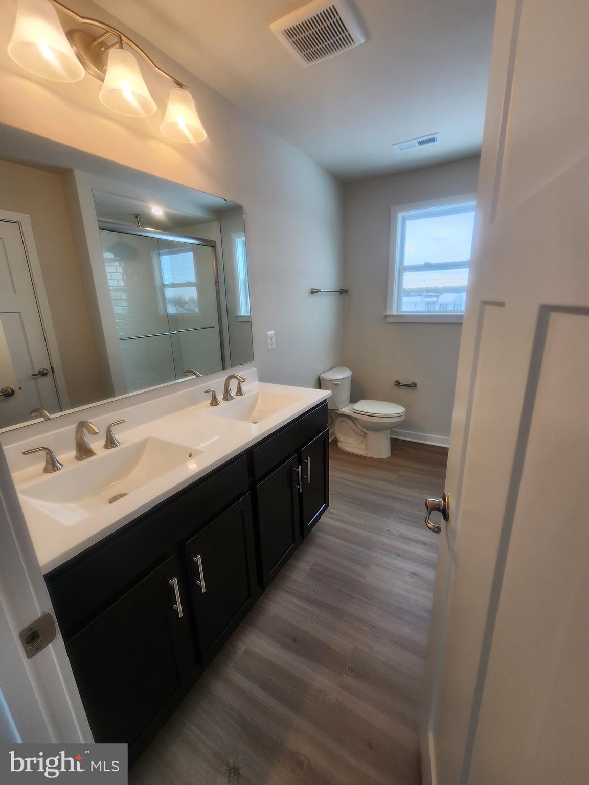 108 Ramshorn Road Inwood, WV 25428 - Photo 9 of 18 a bathroom with a double vanity sink and mirror