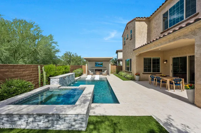 a living room with fireplace furniture and a floor to ceiling window