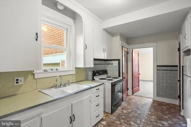 a view of a kitchen from a hallway
