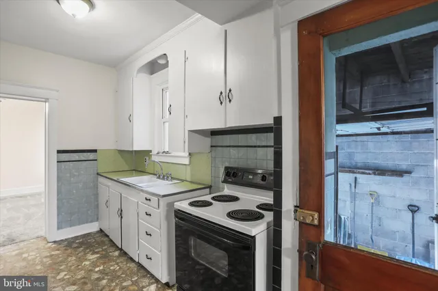 a kitchen with stainless steel appliances granite countertop a refrigerator a stove and a refrigerator with white cabinets