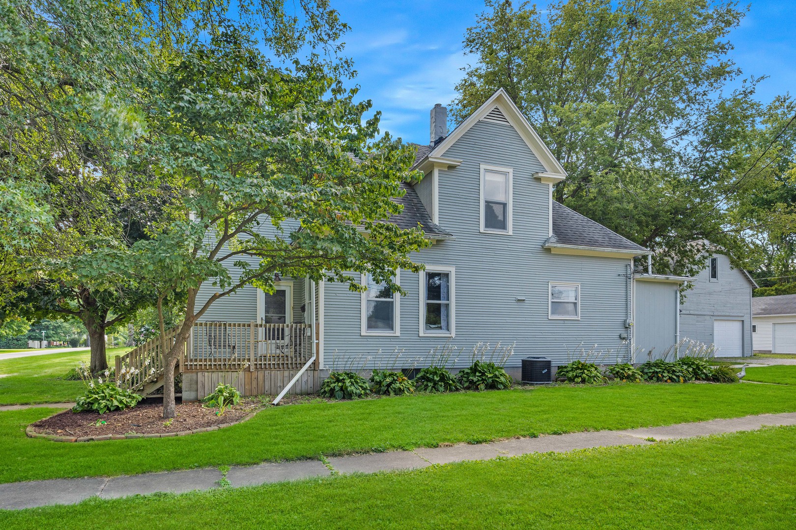 208 North East Street Lexington, IL 61753 - Photo 1 of 38 a front view of a house with a garden and yard