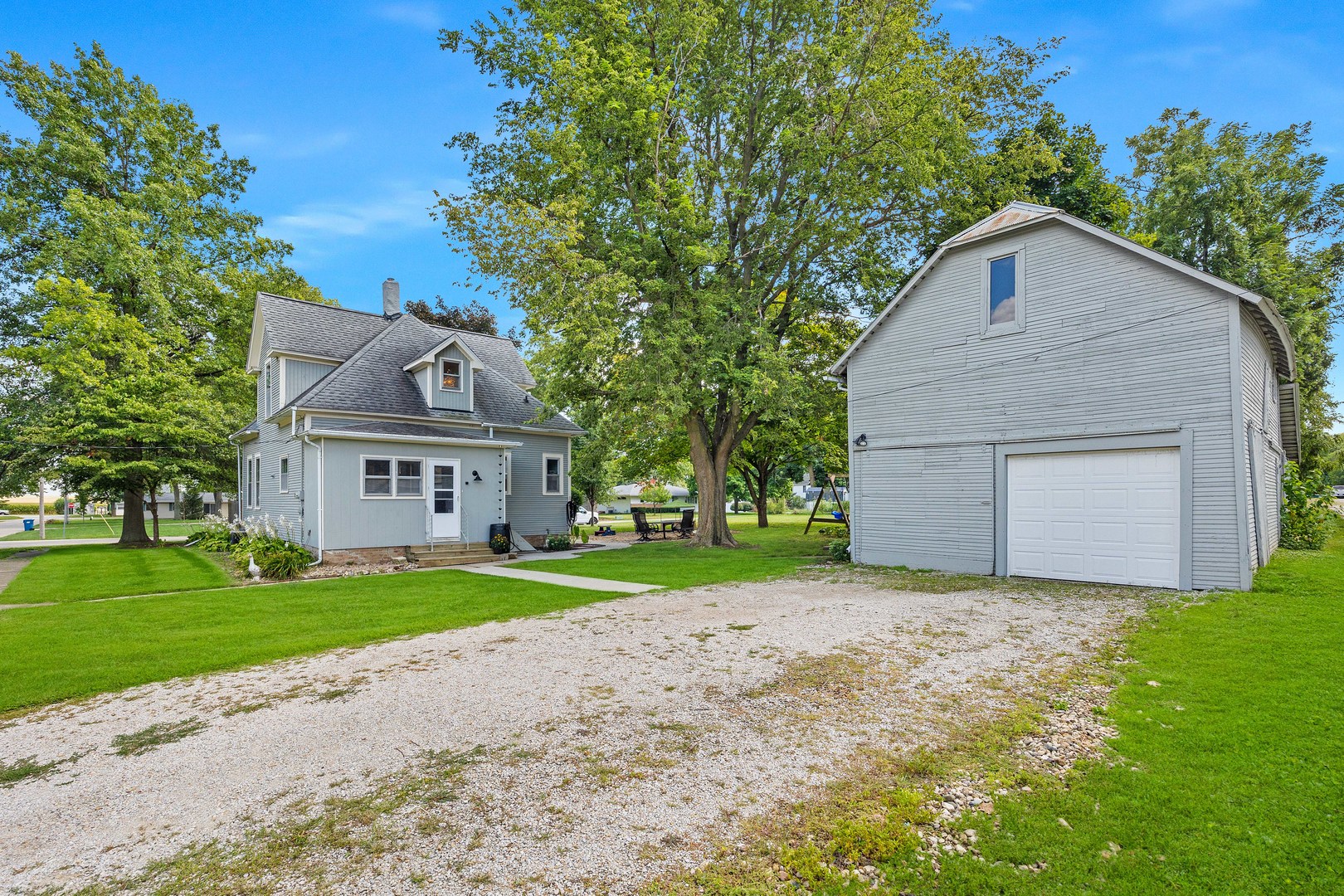 208 North East Street Lexington, IL 61753 - Photo 34 of 38 a view of a house with a yard and large tree