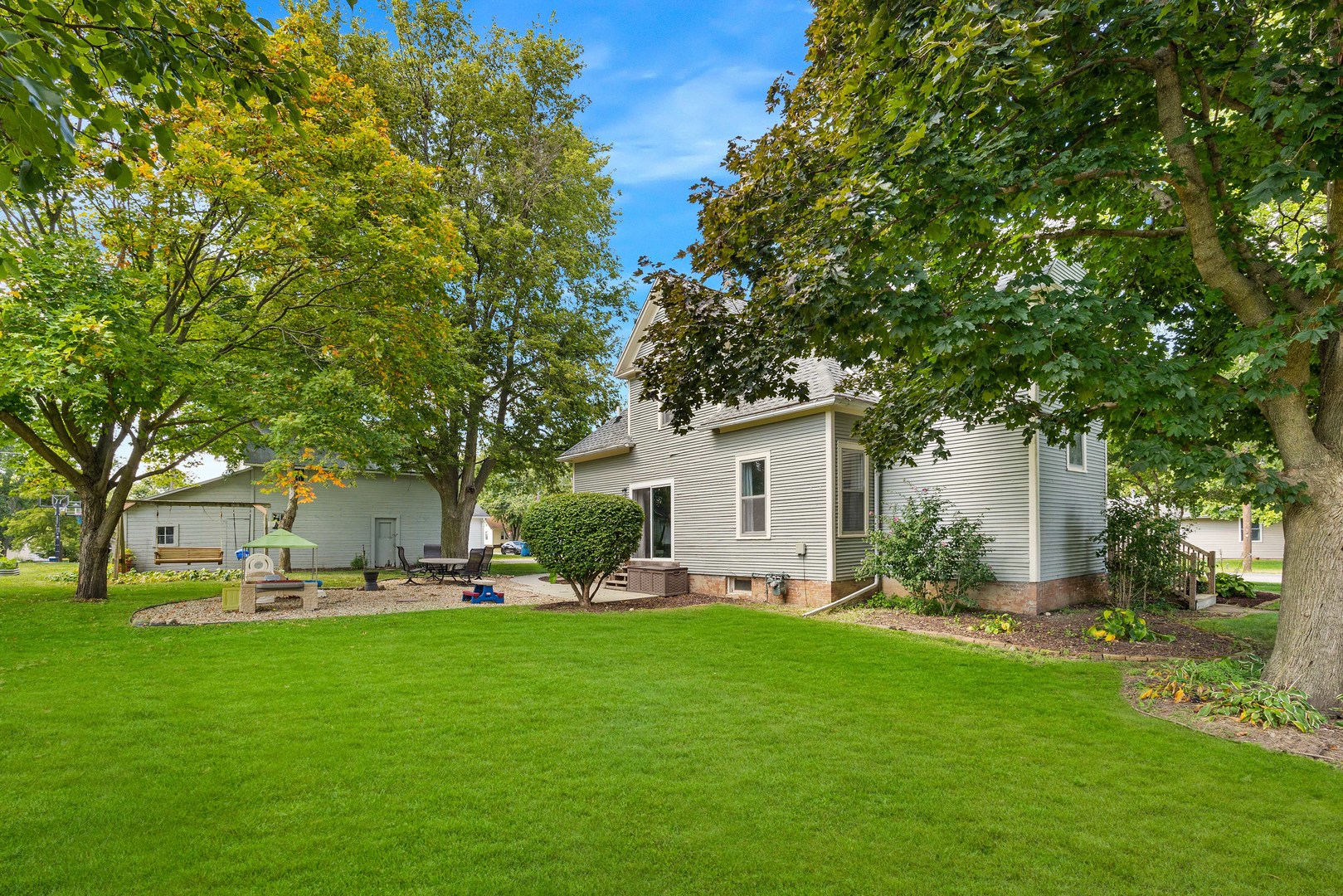 208 North East Street Lexington, IL 61753 - Photo 38 of 38 a front view of a house with a garden and trees