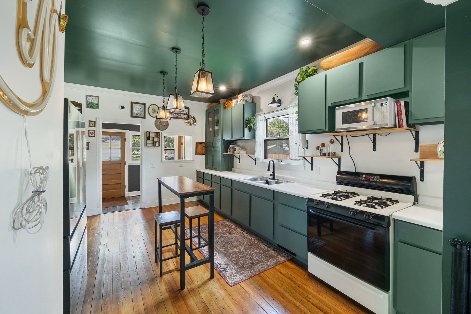 208 North East Street Lexington, IL 61753 - Photo 8 of 38 a kitchen with stainless steel appliances a stove a sink dishwasher and cabinets with wooden floor