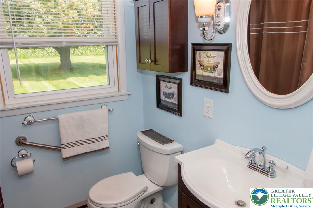 700 Newlins Road East Easton, PA 18040 - Photo 26 of 42 A well-lit lavatory features a crisp white vanity and a window overlooking a verdant lawn.