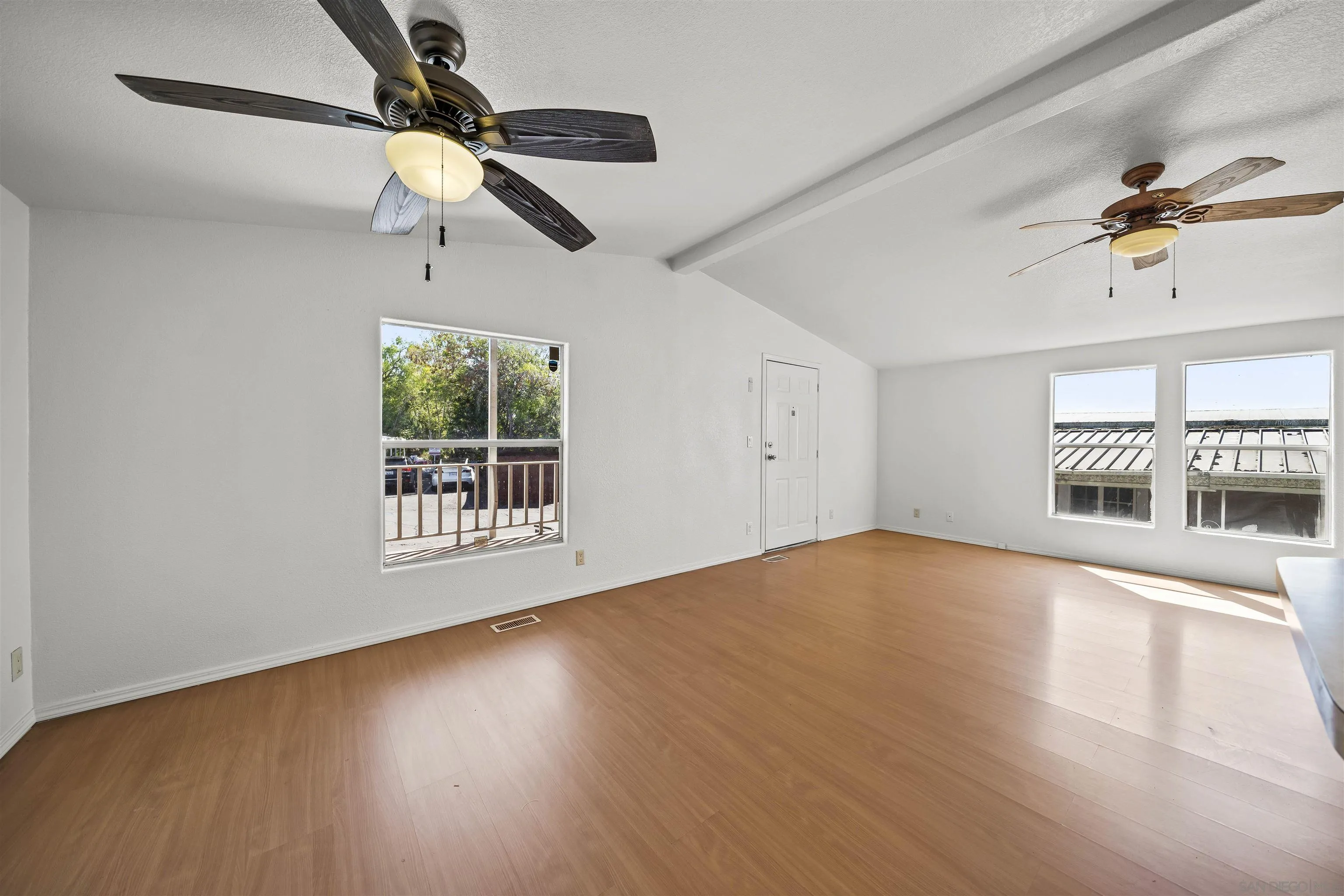 9902 Jamacha Boulevard, Unit 13 Spring Valley, CA 91977 - Photo 16 of 32 a view of an empty room with a window and wooden floor