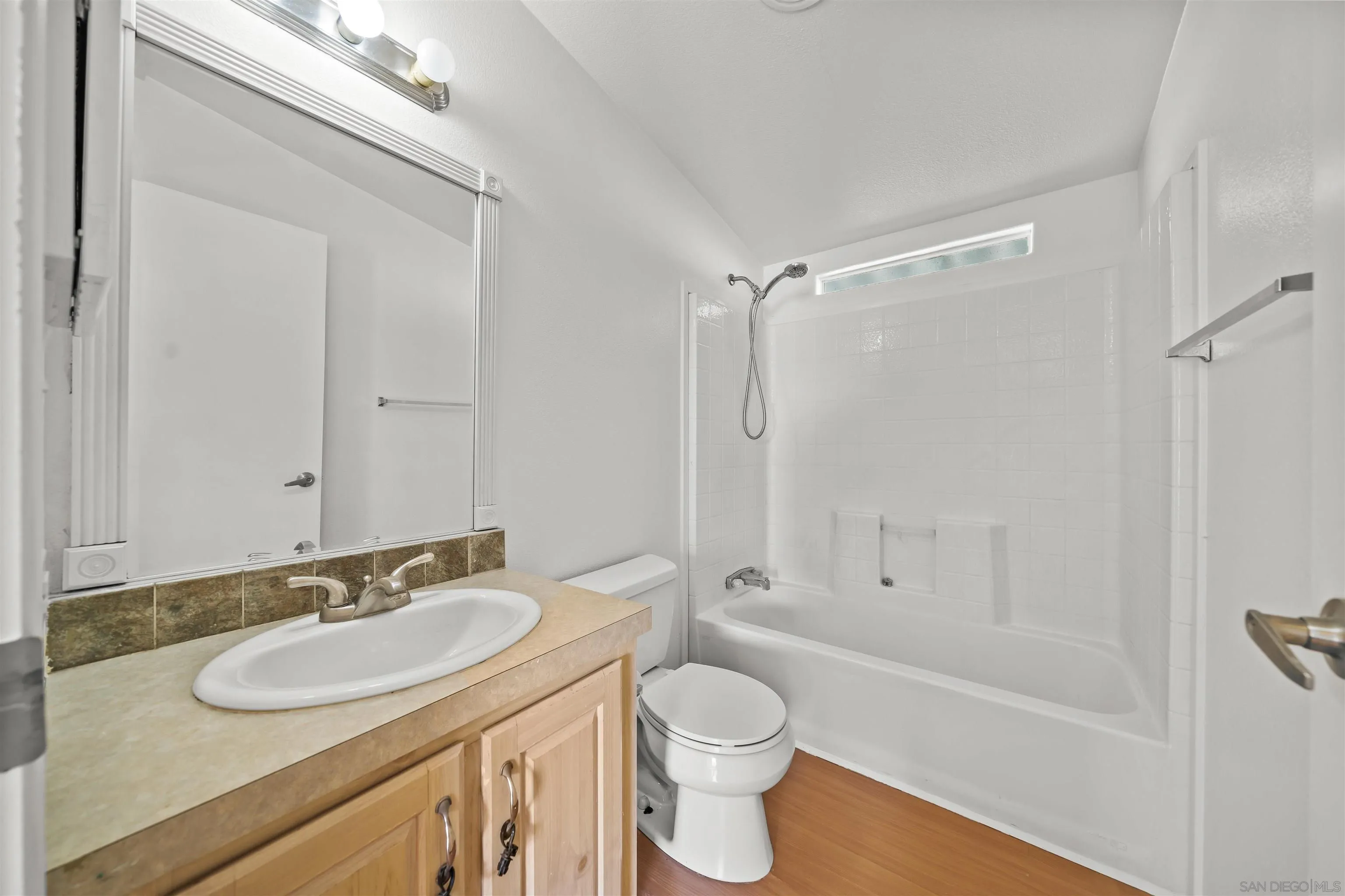 9902 Jamacha Boulevard, Unit 13 Spring Valley, CA 91977 - Photo 18 of 32 a bathroom with a sink toilet a mirror and shower