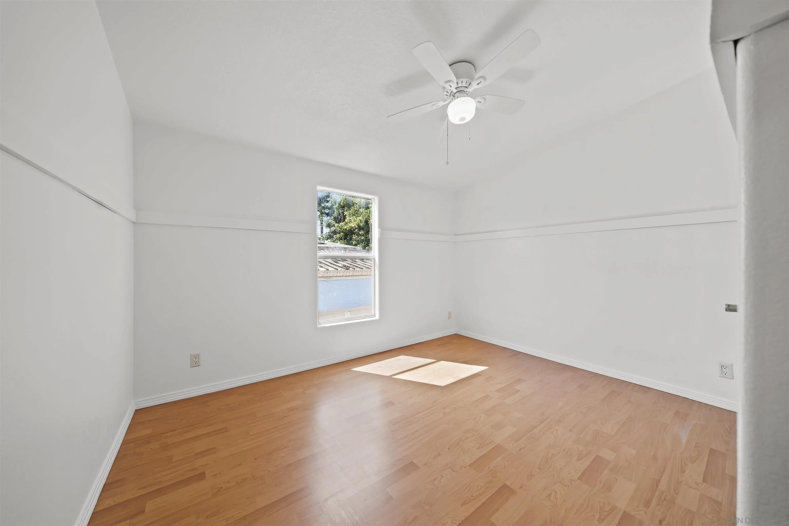 9902 Jamacha Boulevard, Unit 13 Spring Valley, CA 91977 - Photo 21 of 32 an empty room with windows and fan