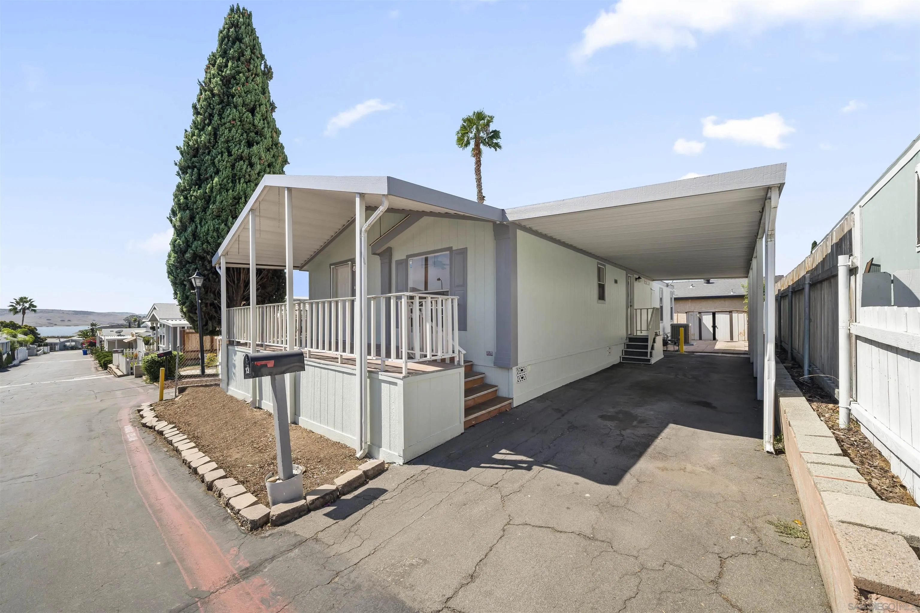 9902 Jamacha Boulevard, Unit 13 Spring Valley, CA 91977 - Photo 29 of 32 a front view of a house with a yard