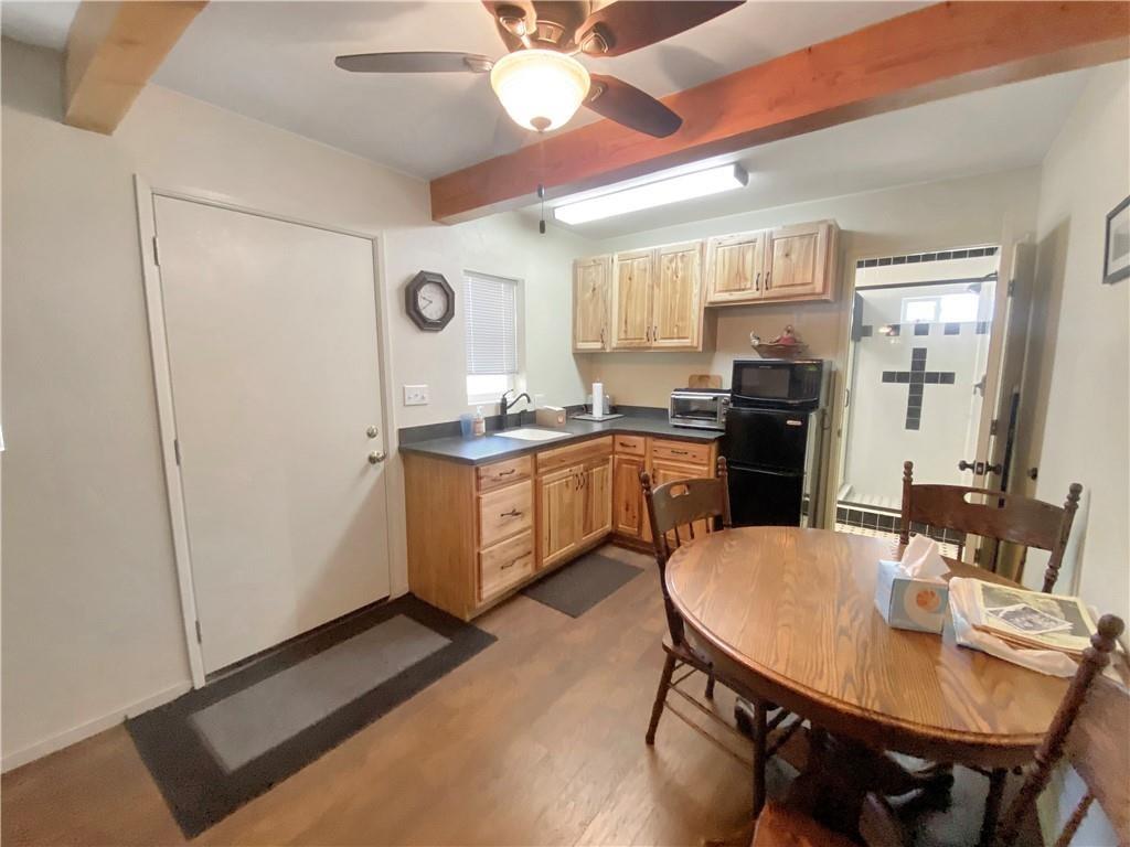 34449 Road 274 North Fork, CA 93643 - Photo 18 of 41 a kitchen with a table chairs refrigerator and cabinets