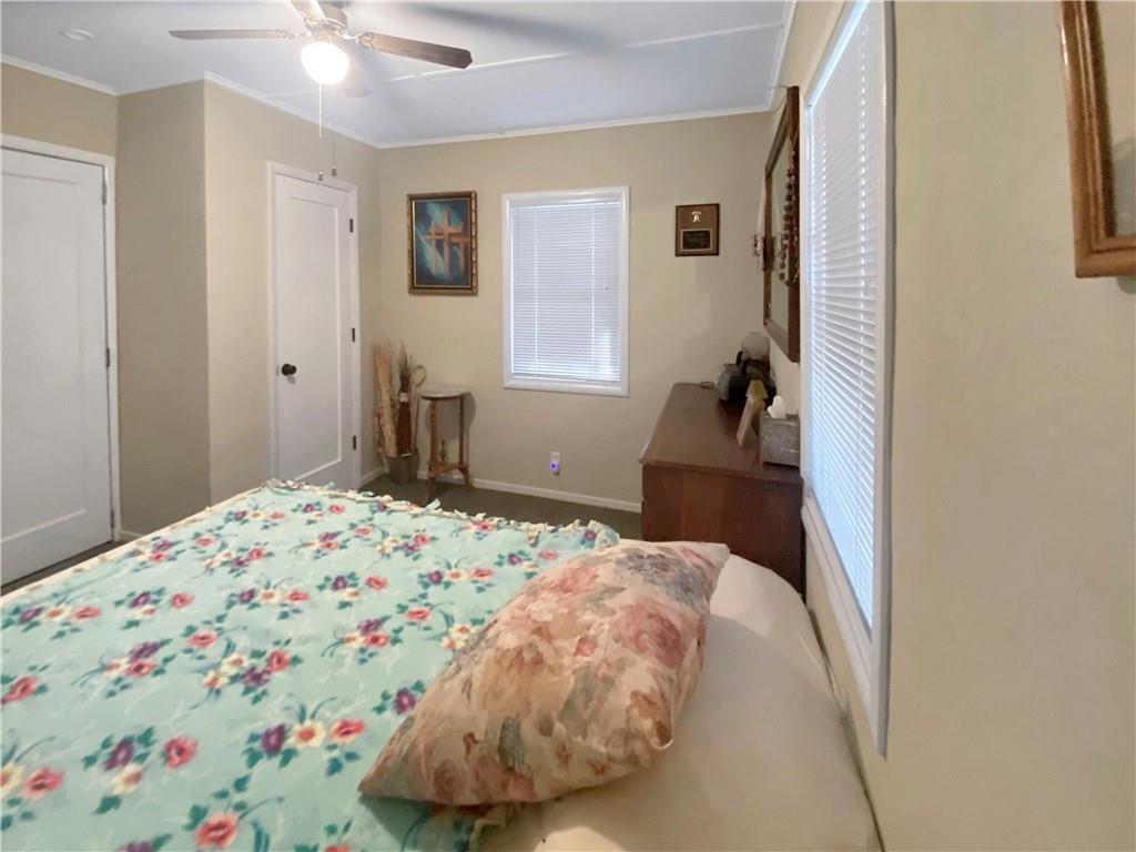 34449 Road 274 North Fork, CA 93643 - Photo 34 of 41 a bedroom with a bed and a chandelier