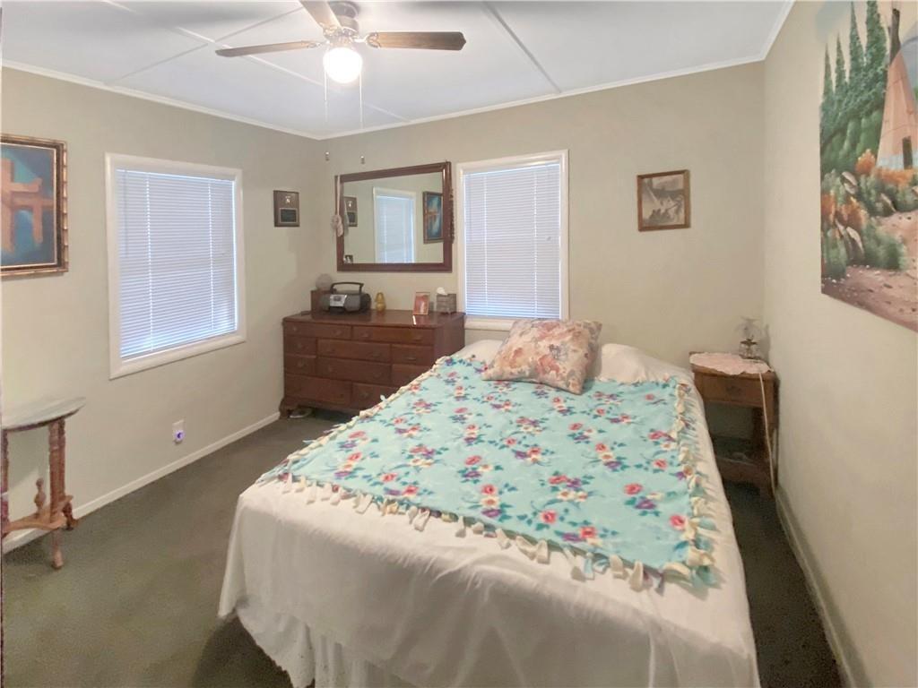 34449 Road 274 North Fork, CA 93643 - Photo 35 of 41 a bedroom with a bed and a chandelier