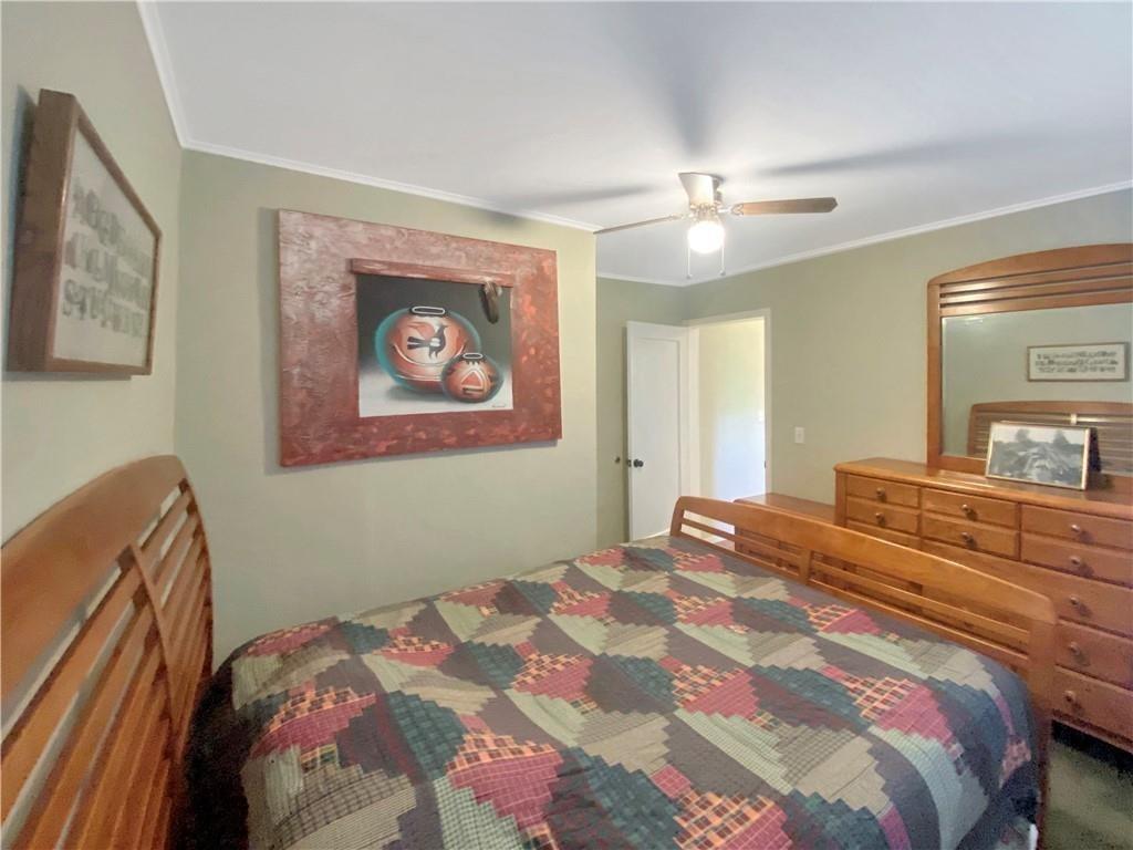 34449 Road 274 North Fork, CA 93643 - Photo 36 of 41 a bedroom with a large bed and a chandelier