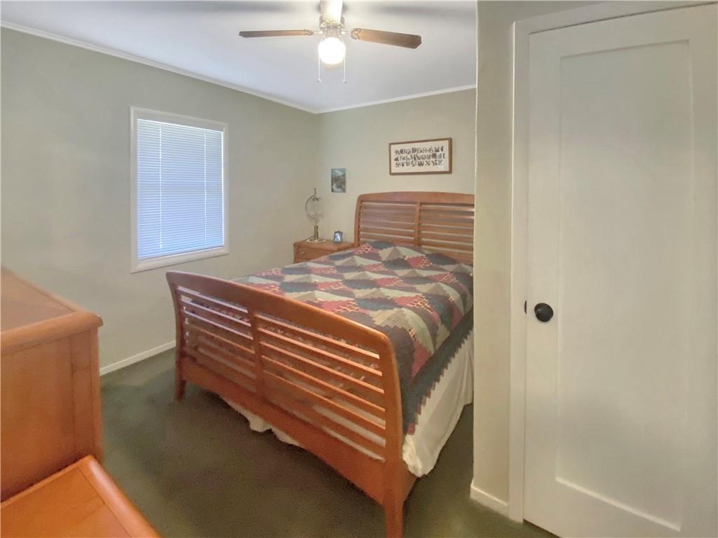 34449 Road 274 North Fork, CA 93643 - Photo 38 of 41 a bedroom with a bed and a chandelier