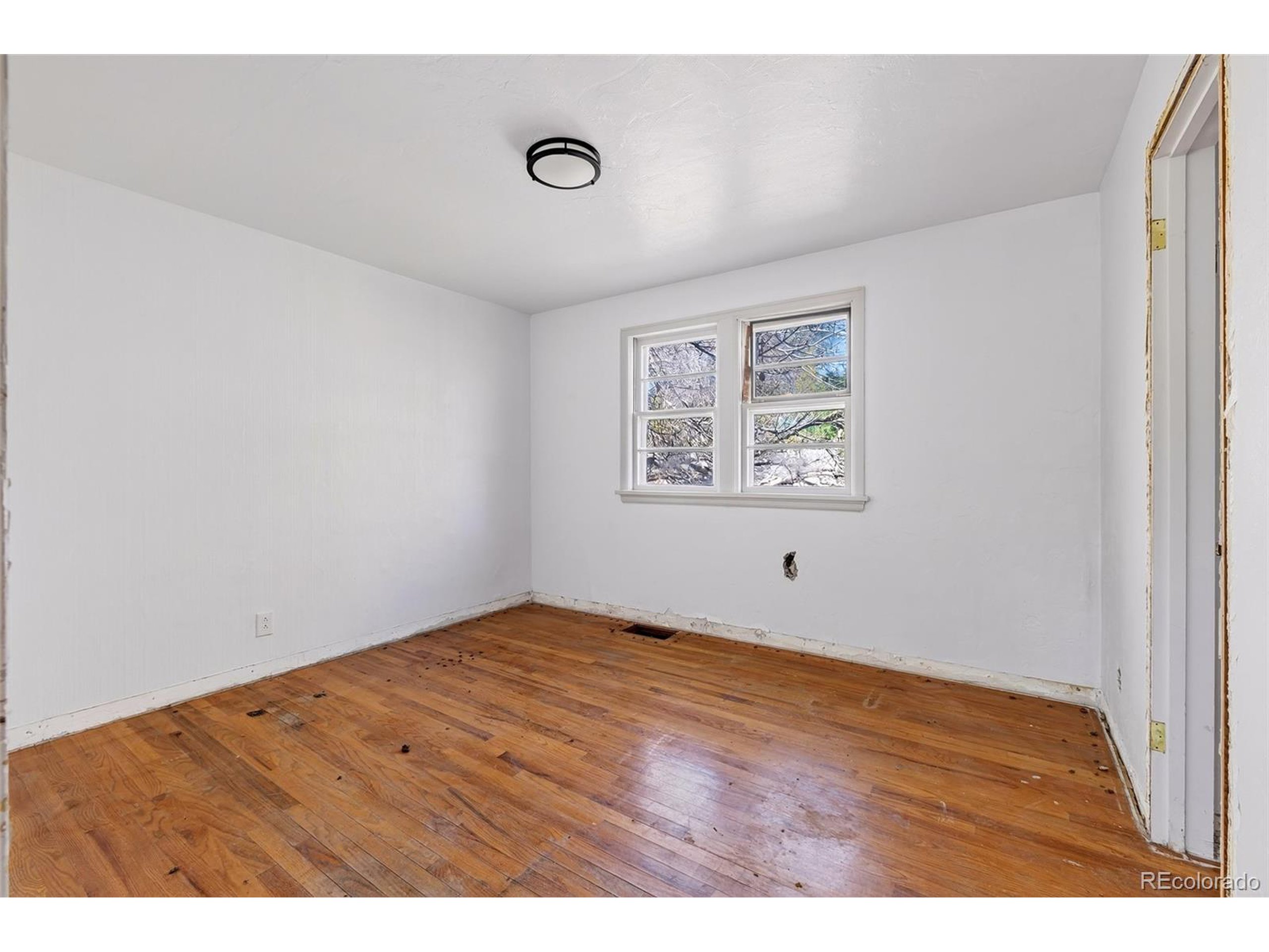6795 West 31st Avenue Wheat Ridge, CO 80214 - Photo 11 of 35 a view of an empty room with wooden floor