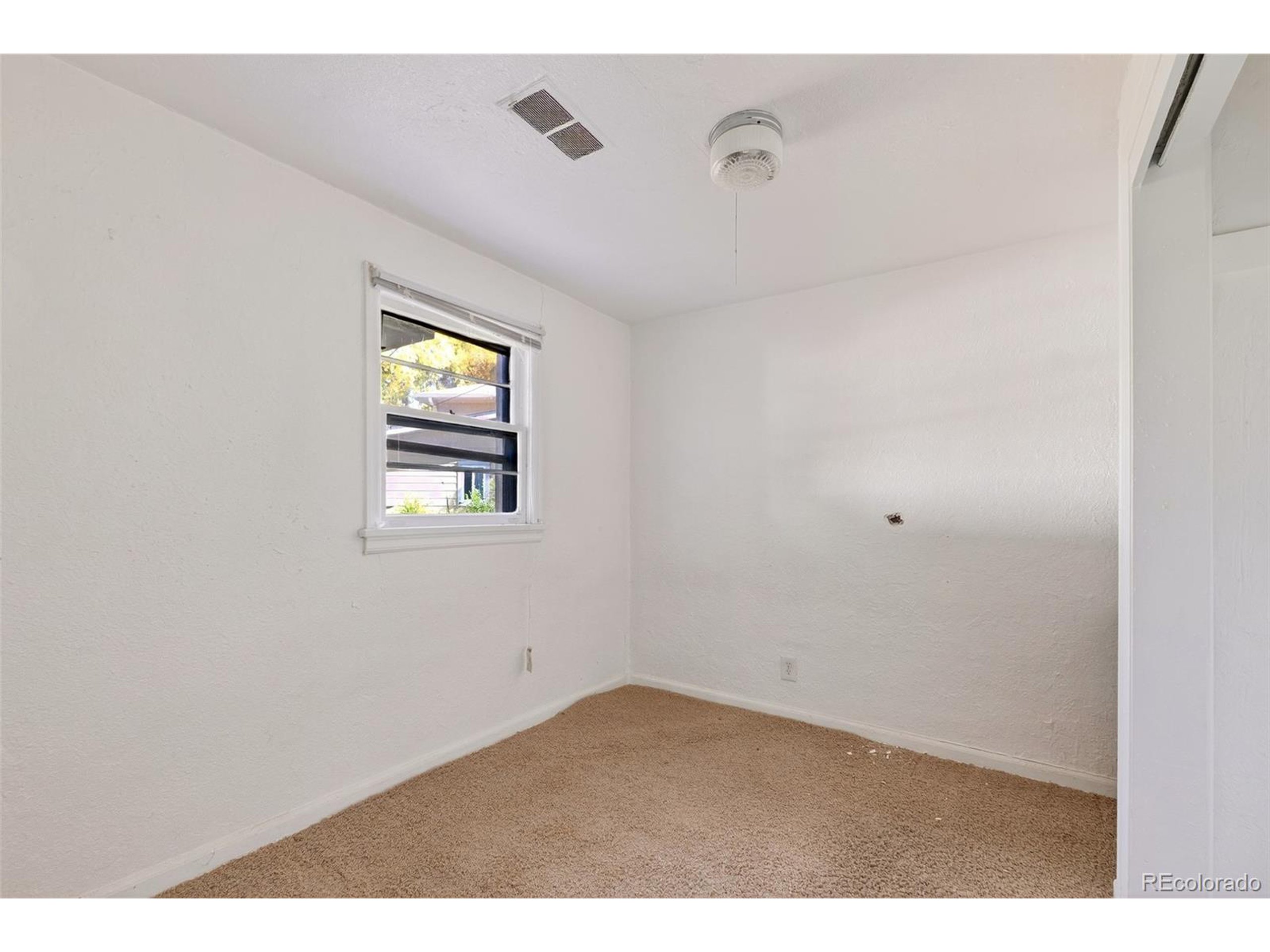 6795 West 31st Avenue Wheat Ridge, CO 80214 - Photo 14 of 35 a view of empty room with windows